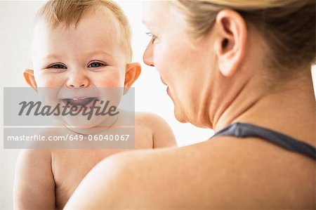 Mother holding smiling baby girl