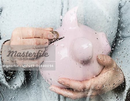 Woman saving money at rainy window