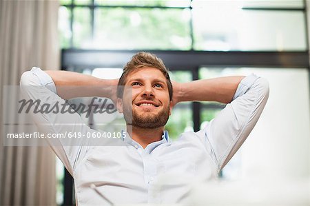 Smiling man relaxing in chair
