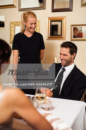 Couple ordering dinner in restaurant