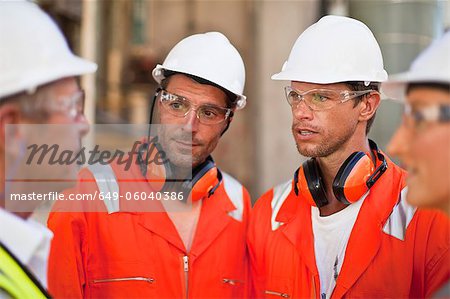 Workers walking at oil refinery