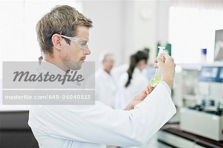 Scientist examining liquid in lab