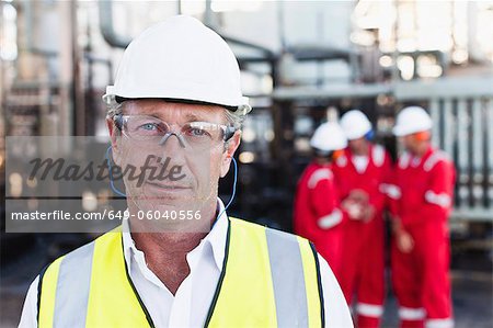 Worker standing at chemical plant Worker standing at chemical plant
