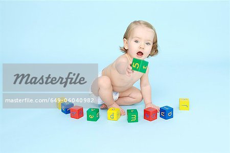 Baby girl playing with colored blocks