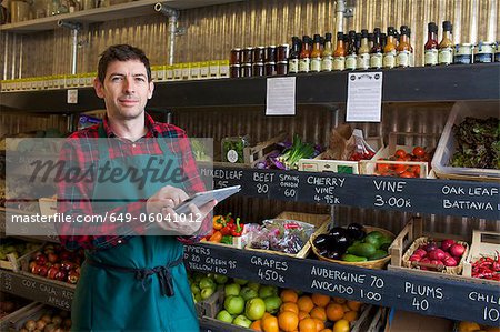 Grocer using tablet computer in store