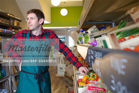 Grocer arranging produce for sale