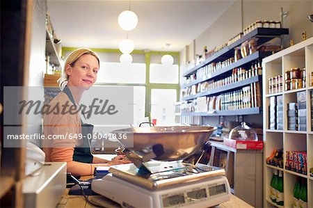Grocer working behind counter at store