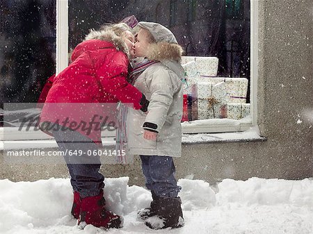 Children kissing in snow