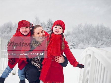 Mother and daughters playing in snow