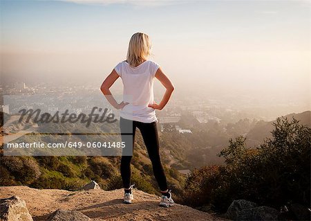 Woman overlooking view from hilltop