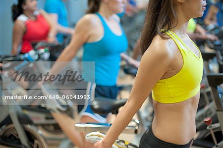 People stretching on spin machines