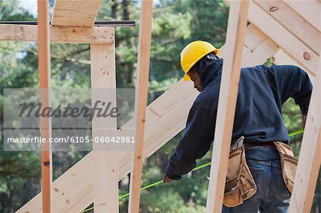 Carpenter measuring rafter length