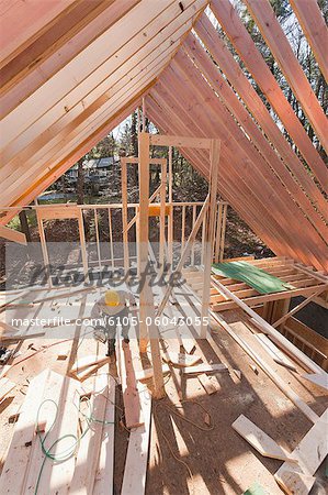 Carpenter working under rafters