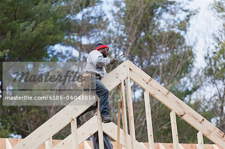 Carpenter working on a roof peak