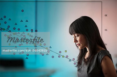 Mature woman with diagram of shapes on window Mature woman with diagram of shapes on window