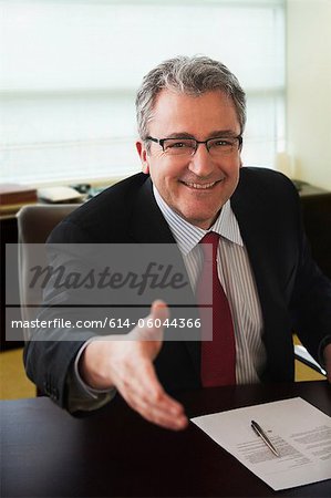 Mature businessman shaking hands at job interview