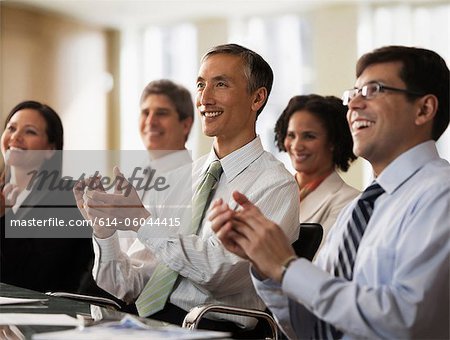 Business colleagues applauding in office