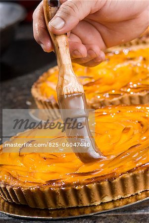 Brushing jelly onto the tarts