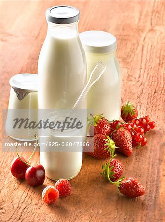 Yoghurts in glass pots,milk in glass bottle and fruit