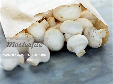 Paper bag of button mushrooms