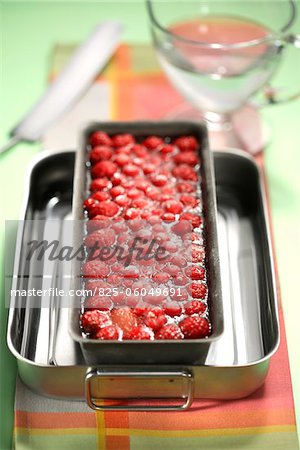 Pouring the gelatine onto the summer fruit in the terrine