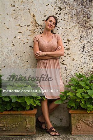 Italy, Ravello, Portrait of woman in dress leaning on wall
