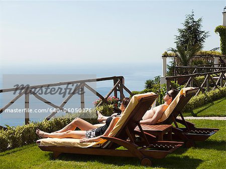 Italien, Küste von Amalfi, Ravello, Mature Couple liegend auf Lounge-Sessel
