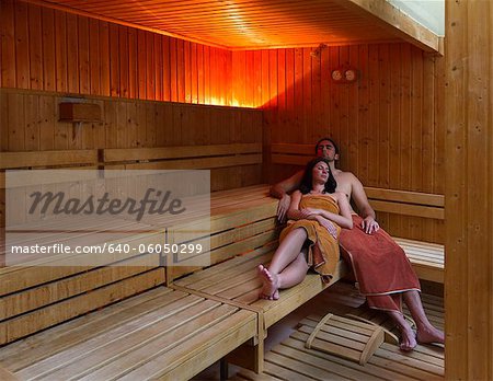 Italy, Tuscany, Young couple relaxing in sauna