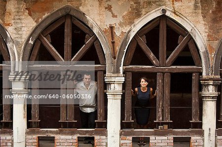 Italy, Venice, Couple standing in arcade