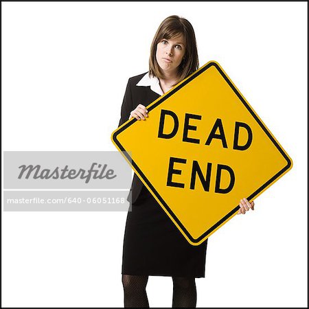 person holding a dead end sign
