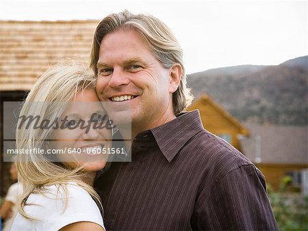 husband and wife smiling