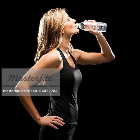 Young woman drinking water from bottle