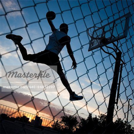 USA,Utah,Salt Lake City,Basketball player slam dunking ball