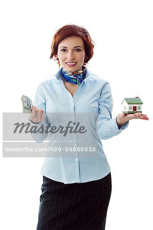 Beautiful young woman holding money and house model over white - real estate loan concept