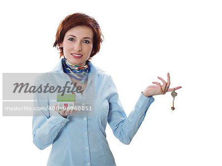 Beautiful young woman holding keys and house model over white - real estate loan concept