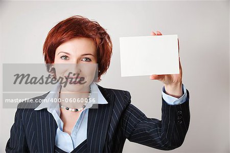 Woman holds out business card. Focus on hand and card
