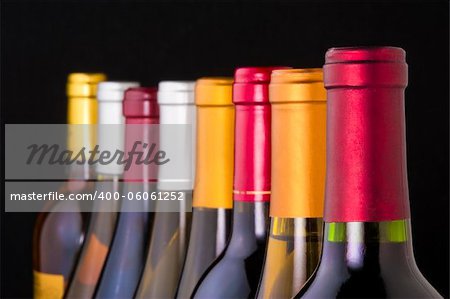 Wine bottle necks with limited depth of field on black