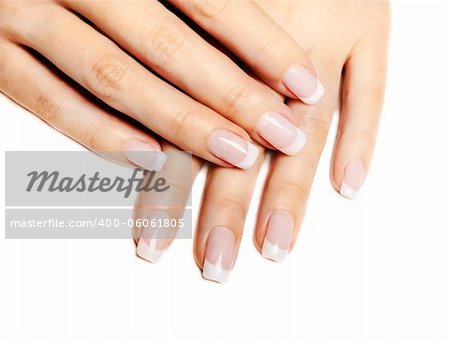 Beautiful female hands with french manicure isolated over white