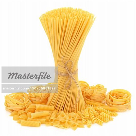 Spaghetti tied in a bunch with string and tagliatelle, conchiglie, rigatoni, farfalle, fusilli and penne pasta  scattered over white background.