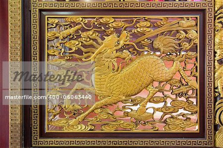Gold Gilt Wood Carving of Qilin on Chinese Temple Wall in Chinatown