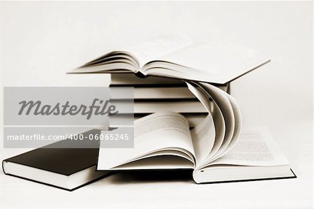 composition of bw books toned to sepia on white background