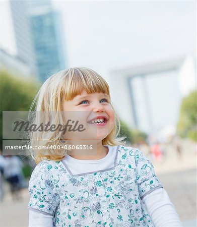 Portrait of the cute little girl walking to la Défense, Paris