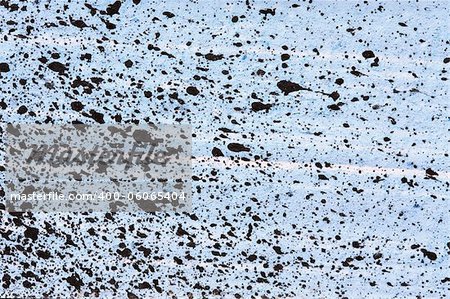 Abstract black paint splatter on blue background