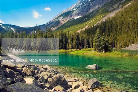 emerald lake at the foot of  the mountains in Sabwatcha canyon,Canada