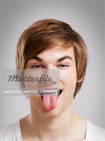 Portrait of a handsome young man, over a gray background