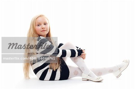 little girl sitting on the floor. Isolated on white.