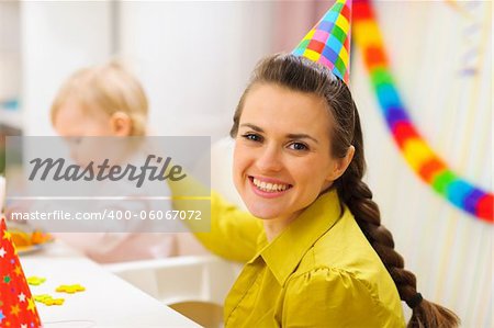 Portrait of happy mother celebrating baby first birthday