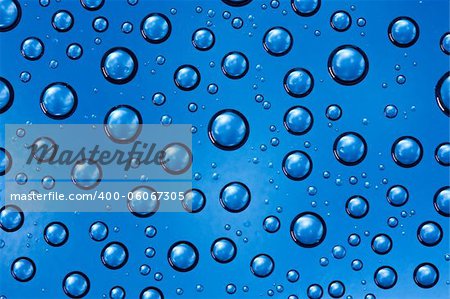 Water drops texture closeup on blue background