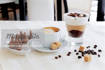 Appetizing coffee and sweets on a table in modern cafe