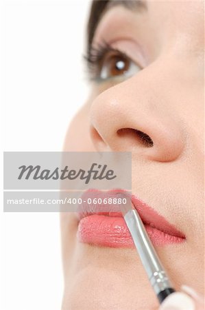 applying liquid glossy lipstick using special brush